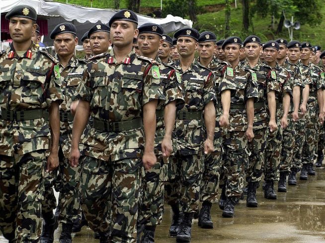 KUKULE, SRI LANKA:  Nepalese troops march past as they take part in a joint drill with security forces from Bangladesh, Mongolia, the US and Sri Lankaat the start of a United Nations Peace Keeping Exercise in the village of Kukule, some 60kms south-east of Colombo, 12 June 2004.  The Multinational Platoon Exercise is aimed at grooming soldiers for United Nations peacekeeping operations with 45 soldiers each from Bangladesh, Mongolia, Nepal and the United States and 70 from Sri Lanka taking part in the two-week exercise.   AFP PHOTO/Sena VIDANAGAMA  (Photo credit should read SENA VIDANAGAMA/AFP via Getty Images)