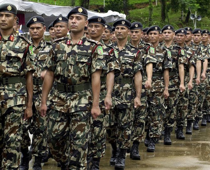 KUKULE, SRI LANKA:  Nepalese troops march past as they take part in a joint drill with security forces from Bangladesh, Mongolia, the US and Sri Lankaat the start of a United Nations Peace Keeping Exercise in the village of Kukule, some 60kms south-east of Colombo, 12 June 2004.  The Multinational Platoon Exercise is aimed at grooming soldiers for United Nations peacekeeping operations with 45 soldiers each from Bangladesh, Mongolia, Nepal and the United States and 70 from Sri Lanka taking part in the two-week exercise.   AFP PHOTO/Sena VIDANAGAMA  (Photo credit should read SENA VIDANAGAMA/AFP via Getty Images)
